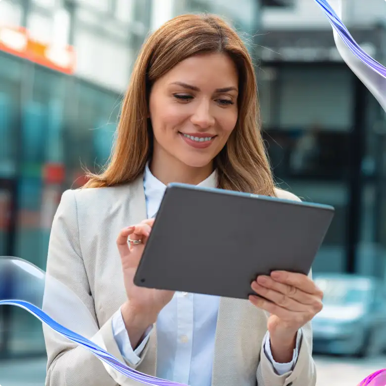 HR Outsourcing Services - Smiling woman using tablet outdoors